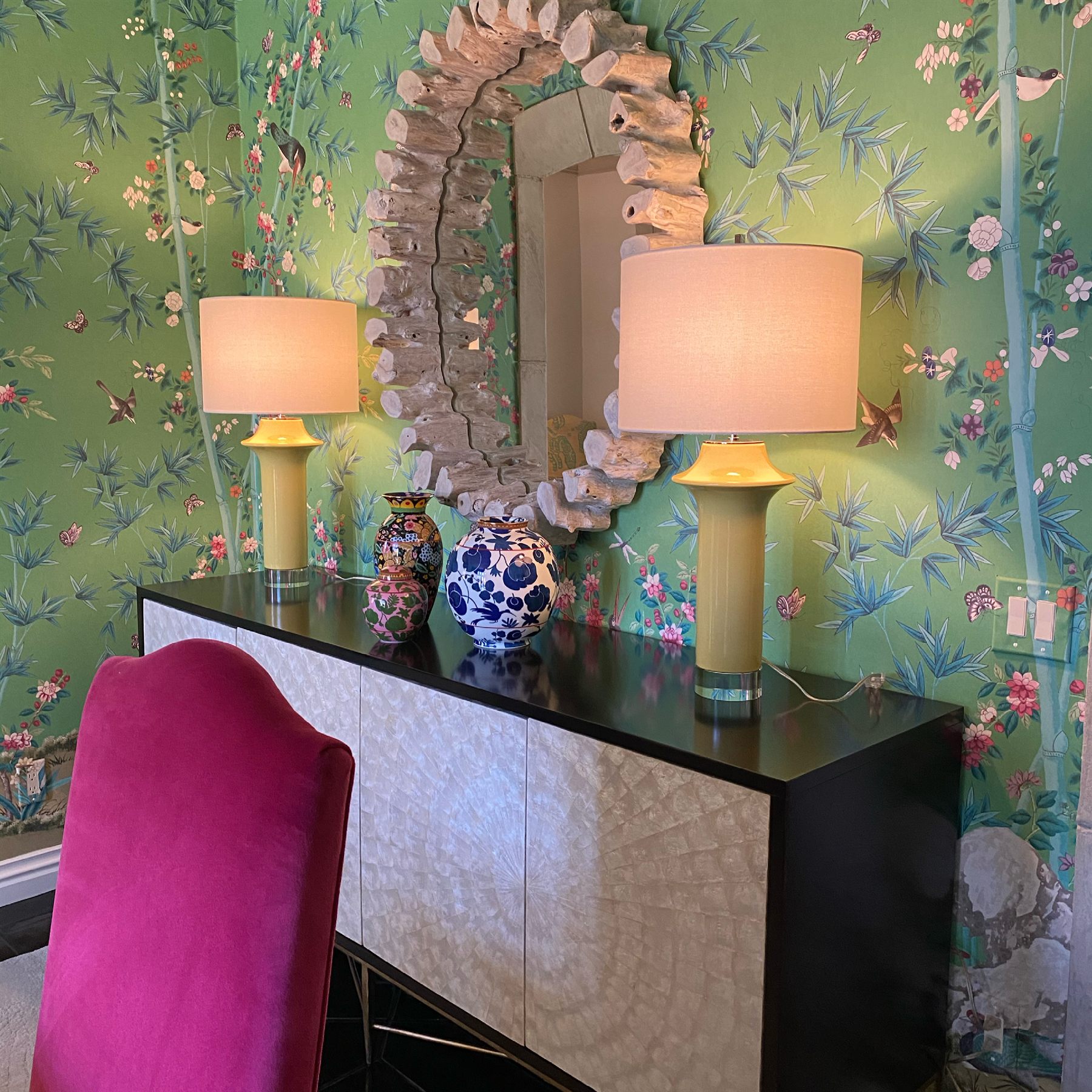 Entry with green chinoiserie wallpaper and stone-frame mirror